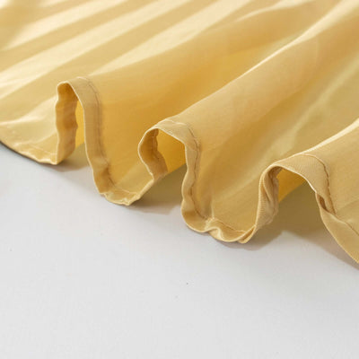 Yellow ruffled fabric close-up showcasing texture and detail.