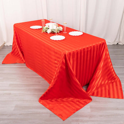 Red striped tablecloth draped over a table with decorative elements.