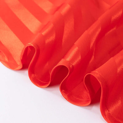 Red satin fabric with elegant stripes and soft draping.