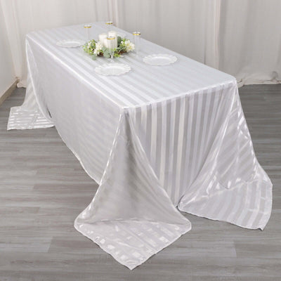 Elegant white striped tablecloth draped over a long table.