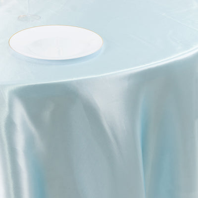 Elegant light blue tablecloth draped over a table with a white plate.