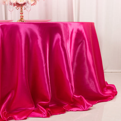 Bright pink satin tablecloth draping elegantly over a table.