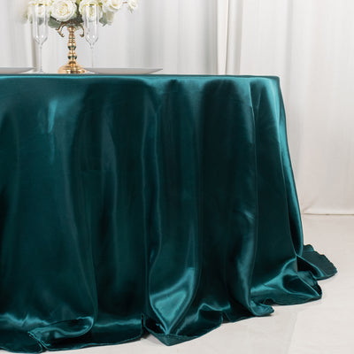 Teal satin tablecloth draped elegantly over a table