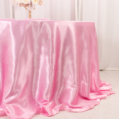 Pink satin tablecloth elegantly draping over a table.