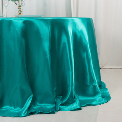 Teal satin tablecloth draping elegantly over a table.