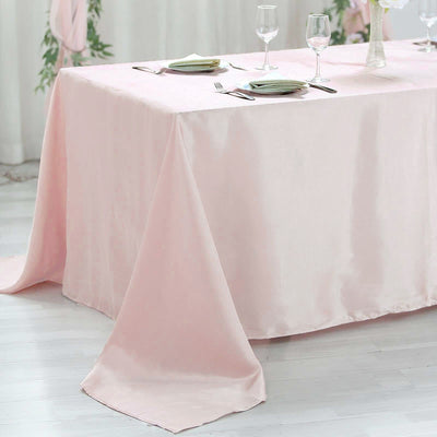 Pink tablecloth draped elegantly over a table, set for a dining occasion.