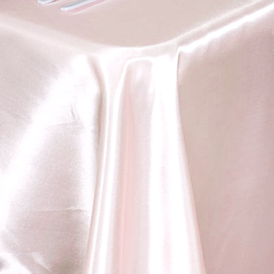 Pink satin fabric draped elegantly on a surface.