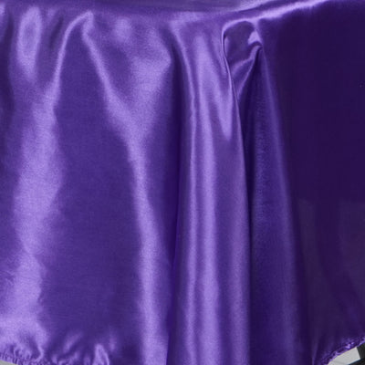 Purple satin fabric draped elegantly, showcasing its smooth texture and sheen.