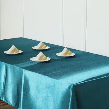Elevate Your Event with the Peacock Teal Satin Rectangular Tablecloth
