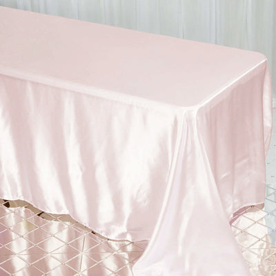 Pink satin tablecloth draped elegantly on a table.