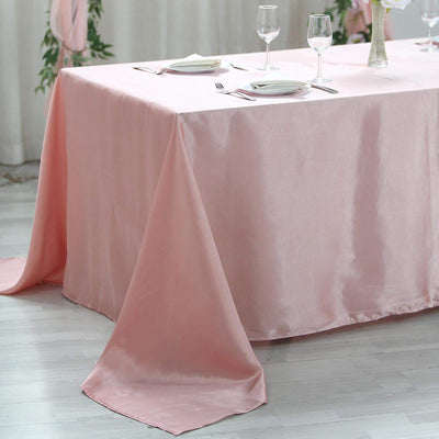 Elegant pink satin tablecloth draped over a table for special occasions.