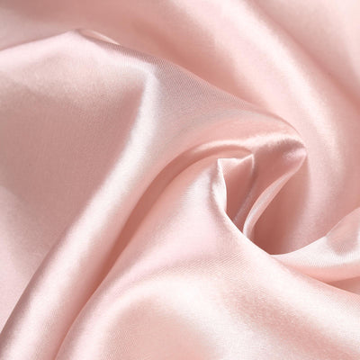 Soft pink satin fabric with elegant drapes and smooth texture.