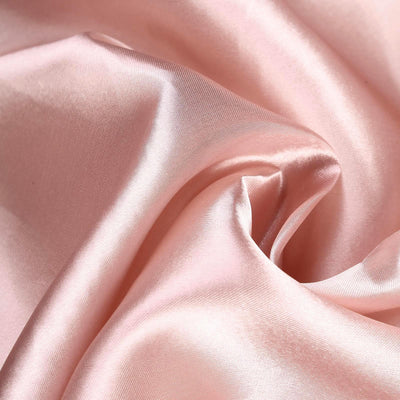 Soft pink satin fabric draped elegantly, showcasing its smooth texture.