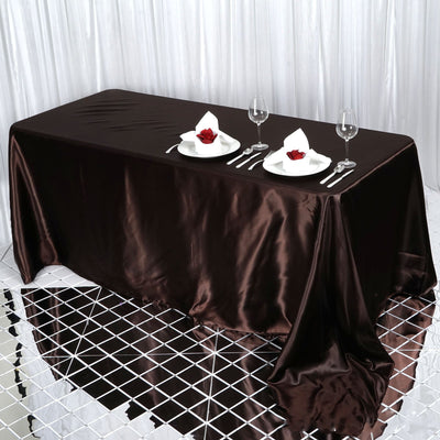Elegant brown satin tablecloth with place settings and wine glasses.