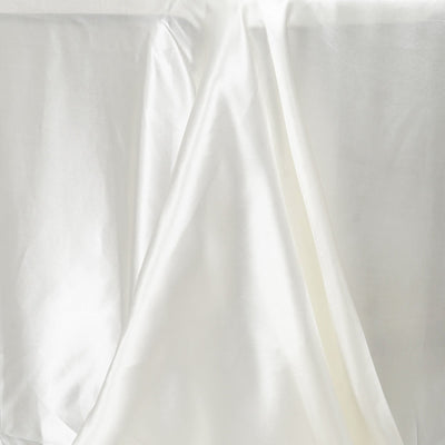 White satin fabric draped elegantly, showcasing its smooth texture and sheen.