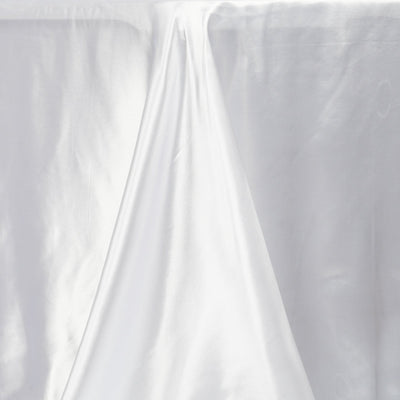 White satin fabric draped elegantly on a table