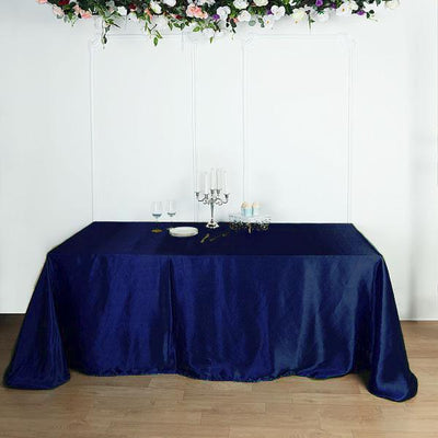 Navy blue tablecloth draping over a table with elegant decor