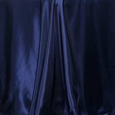 Navy blue satin fabric draped elegantly, showcasing smooth texture and sheen.