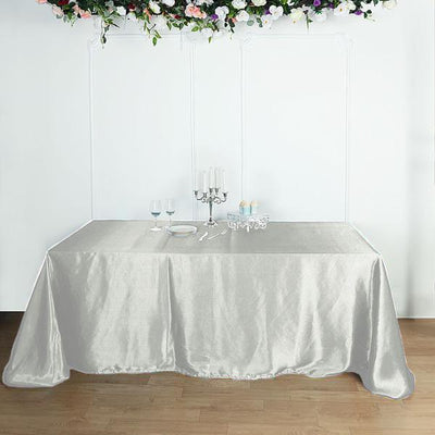 Elegant silver tablecloth draped over a table, perfect for events and gatherings.