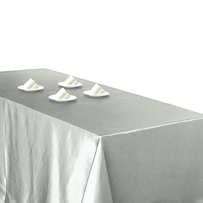 Gray tablecloth with four small plates arranged on top