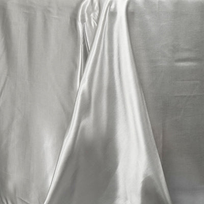 Shiny silver fabric draped elegantly on a surface.