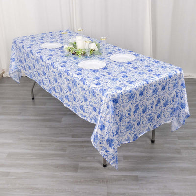 Table set with a blue floral tablecloth and decorative centerpiece.