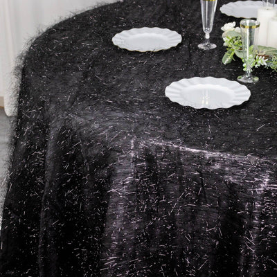 Black tablecloth with shimmering threads, elegantly draped on a table.