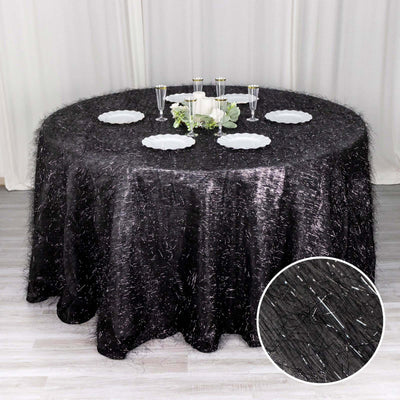 Round black tablecloth with sparkly texture, elegantly draped on a table.