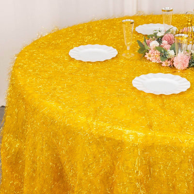 Yellow shimmering tablecloth with white plates and floral centerpiece.