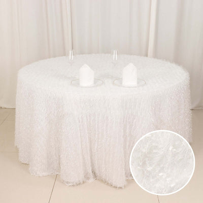 White round tablecloth with textured design and elegant glassware