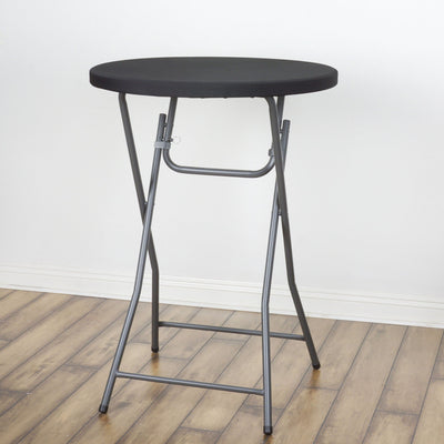 Black folding table with gray legs on a wooden floor.