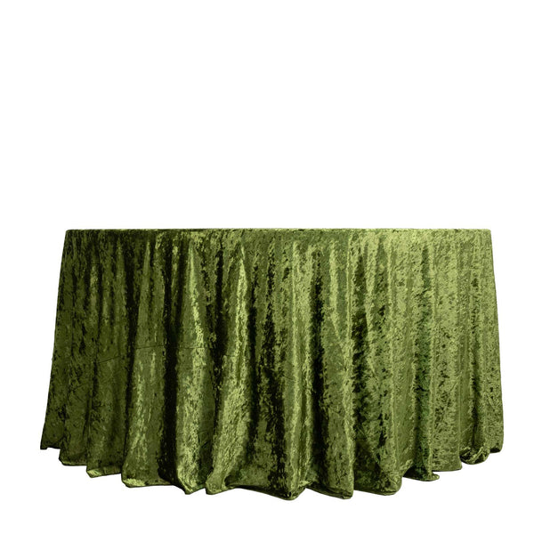 Round table with green velvet tablecloth on white background