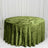 Round table with green velvet tablecloth against white draped backdrop