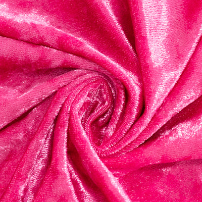 Pink velvet fabric texture close-up, showing soft, luxurious shine.
