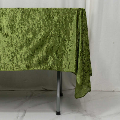 Green velvet tablecloth draped over a table in a minimalist room