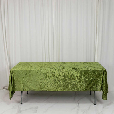 Green velvet rectangular tablecloth on banquet table with white backdrop