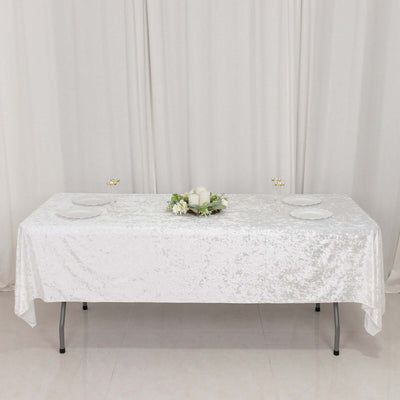 Elegant white table with a textured tablecloth and floral centerpiece