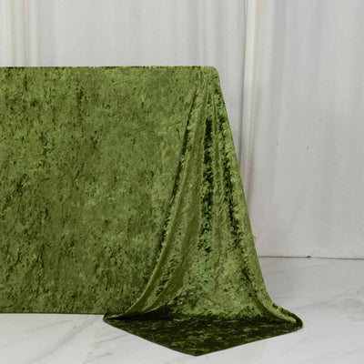 Green velvet fabric draped over a table in a studio setting