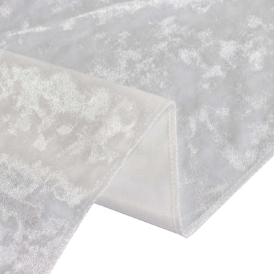 White textured fabric draped elegantly, showcasing its soft sheen and intricate pattern.