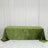 Green velvet tablecloth draped over a rectangular table against white curtains