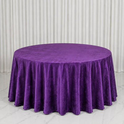 Purple velvet round tablecloth on a round table in a studio setting