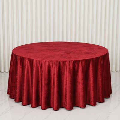 Red velvet round tablecloth on elegant banquet table
