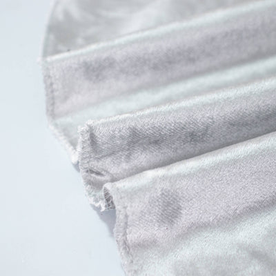 Close-up of folded light gray fabric with visible stitched seams