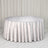 Round silver table with elegant metallic tablecloth and draped backdrop