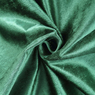 Luxurious green velvet fabric swirl close-up, showcasing rich texture and sheen.