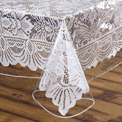 Lace tablecloth draping elegantly over a wooden table edge.