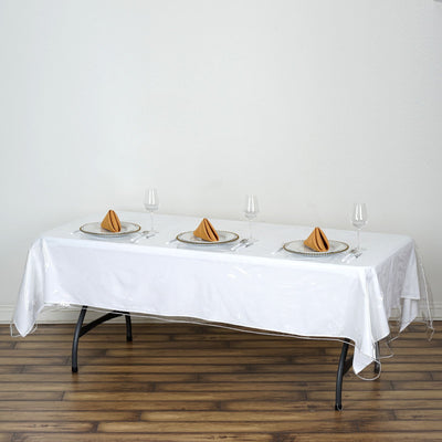 Elegant dining table setup with tableware and napkins.