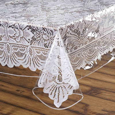 Clear lace table cover with intricate floral design.
