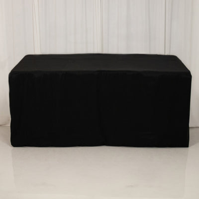 Black table cover draped over a table, studio isolation shot.