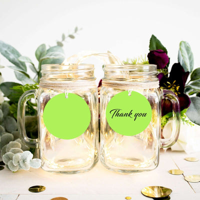 Thank you mason jars with green tags and decorative foliage
